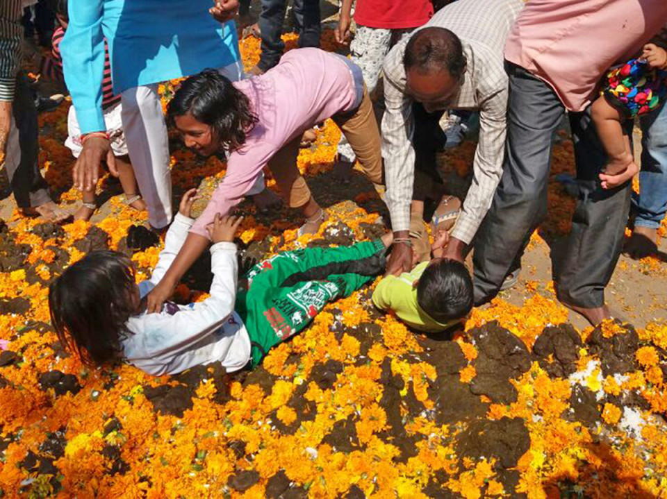 Photos: Indian Mothers Dip Their Babies And Children Inside A Big Pile Of Cow Shit For Goodluck insurance In The Name Of Hindu Rituals (Must See)